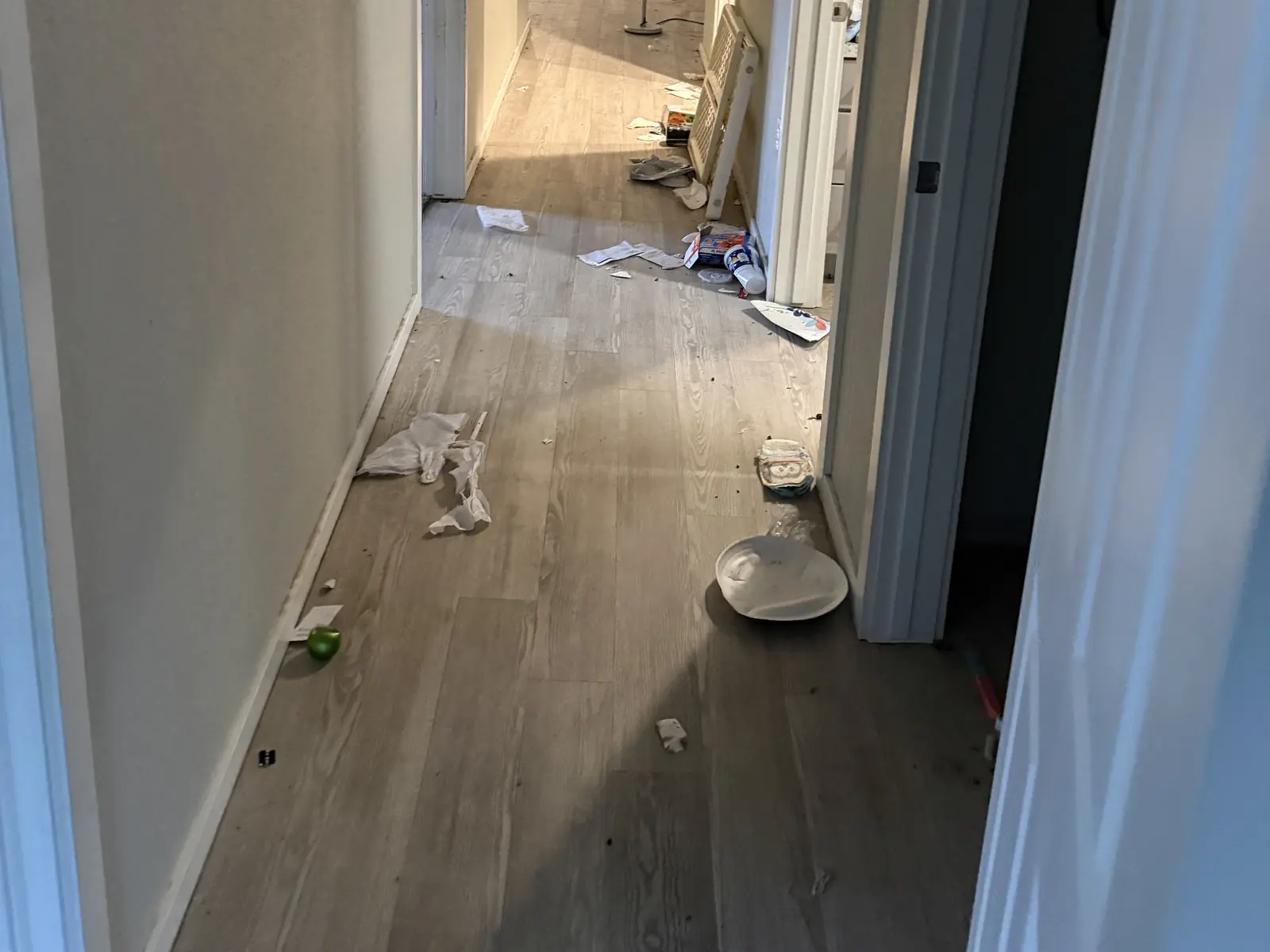 Household debris in a hallway before a property cleanout