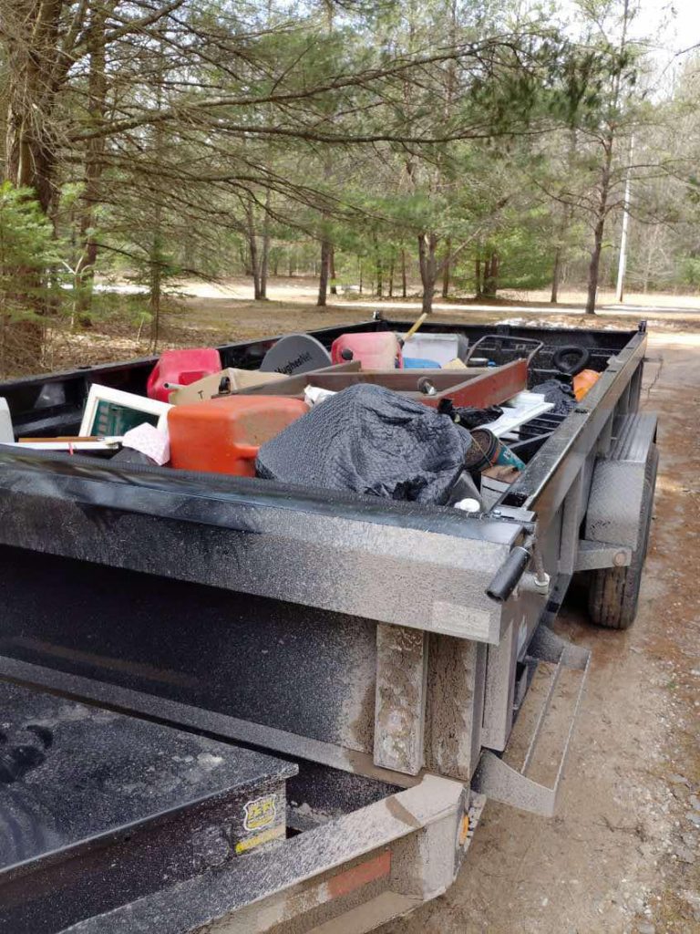 Mixed household items loaded in a Big Dogg dump trailer