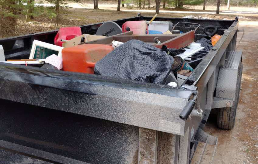 Bulky household items loaded in a dump trailer